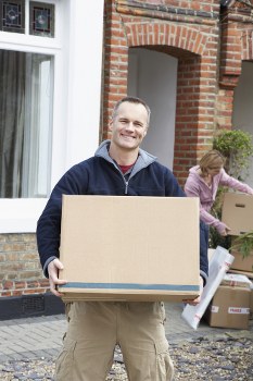 Removal team preparing a flat move in Barnes with boxes and furniture