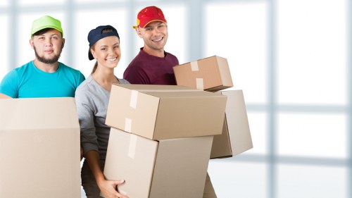 Loading furniture into a van on a Barnes residential street